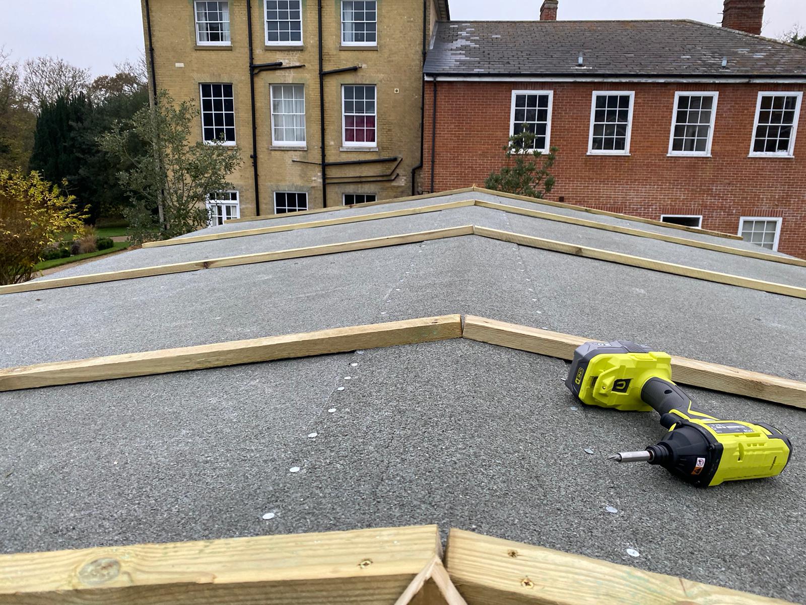 New flat roof deck with timber edging, period houses behind