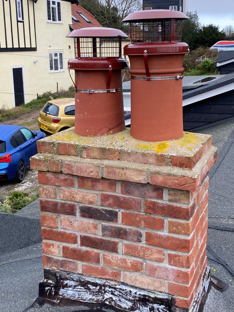 Rebuilt brick chimney stack with new terracotta cowls