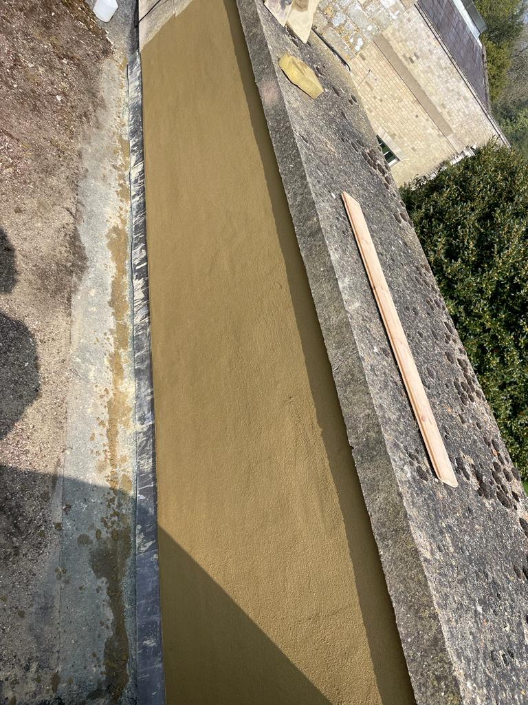 Newly lined box gutter along a roof edge